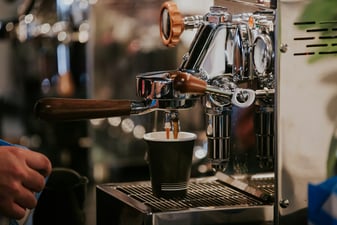 Black and silver espresso machine on a home counter, ready to pull a shot
