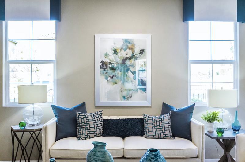 Living room with blue accents and cream couch