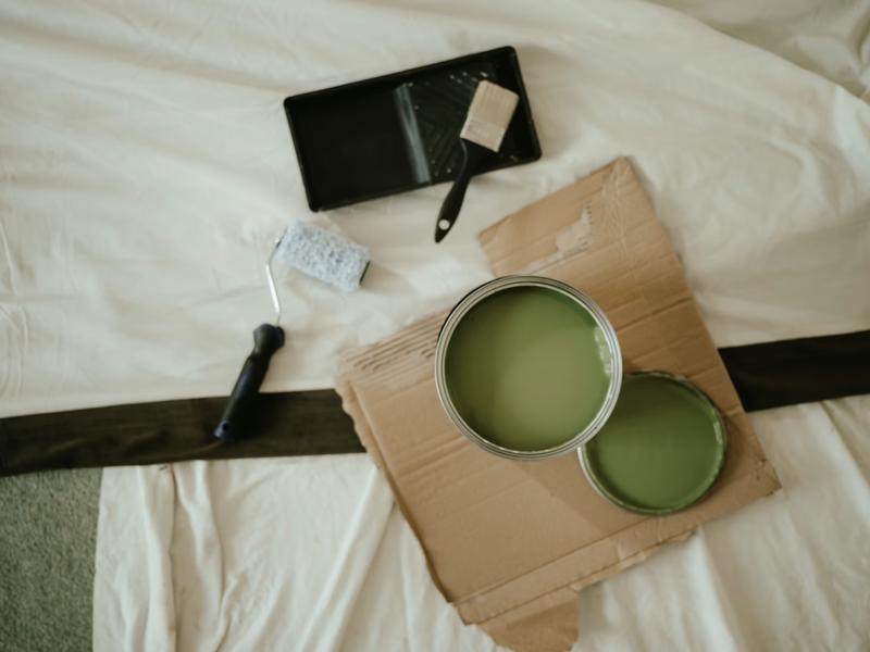 Paint can and roller on drop cloth