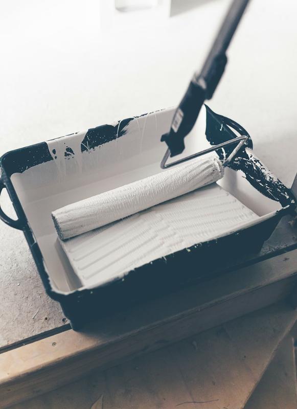 Paint roller in tray ready for work